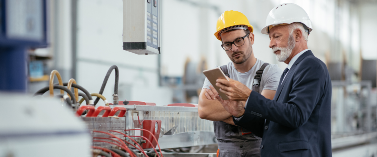 2 men performing a compliance audit in a factory